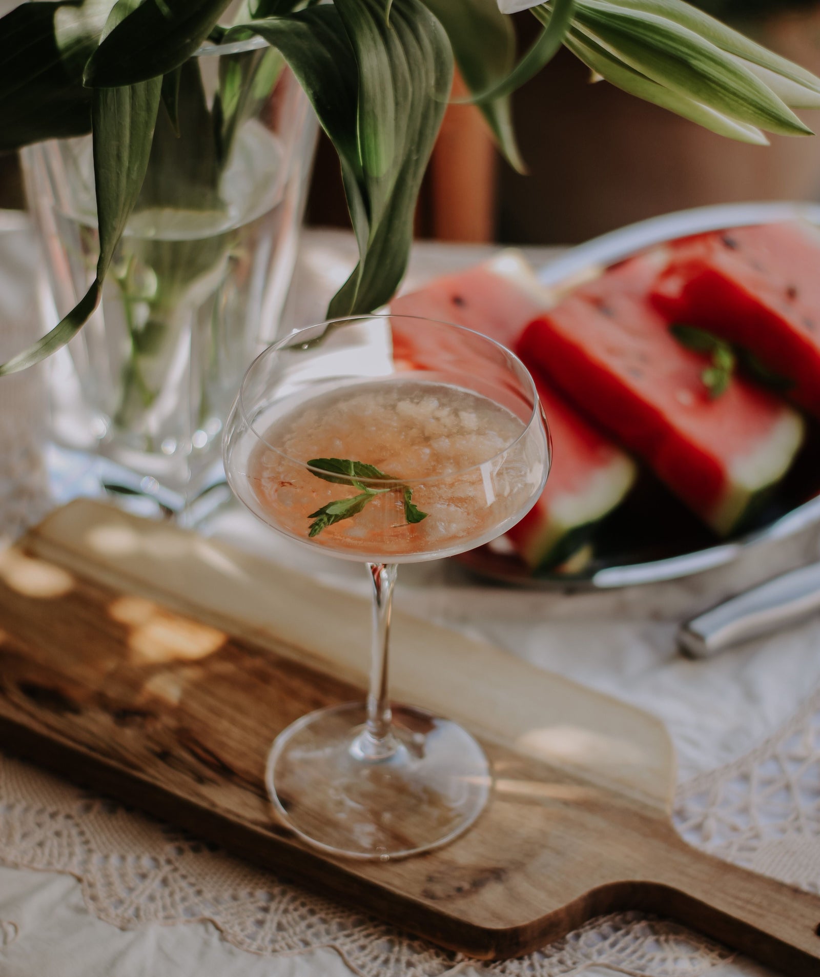 A watermelon and mint cooler made with sparkling water, the drink to make in a heatwave, in a glass with ice and fresh mint.